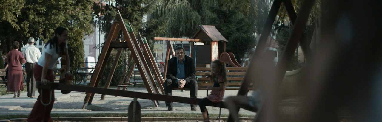 Man sitting alone at playground.