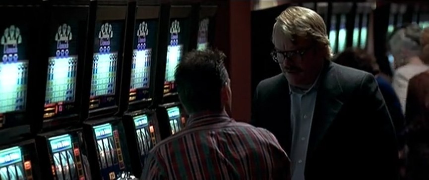 Man upset at other man at slot machine